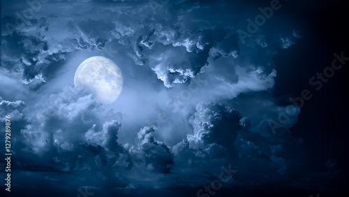 Night sky with moon light. Dramatic clouds in mystic moonlight. Large bright moon as concept of mystery, midnight, gothic time and spooky theme. Moody sky texture background.