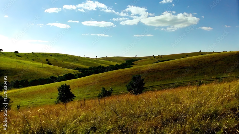 Fototapeta premium Rolling green hills under a bright blue sky peace