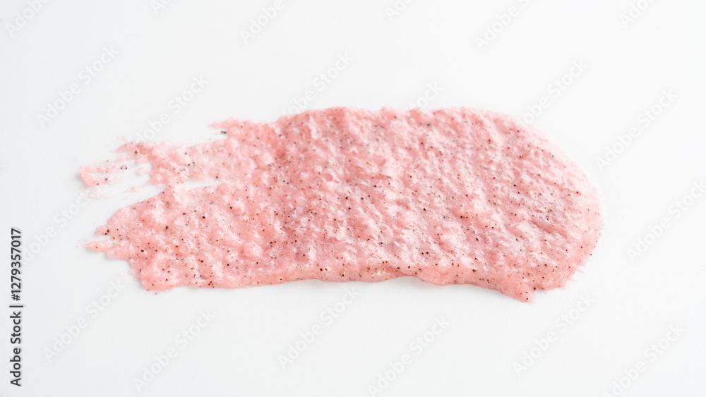 Pink substance is on a white background. It looks like a brush stroke. The brush stroke is pink and has a rough texture