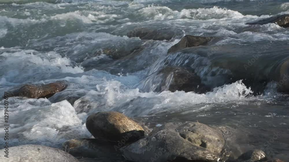 Mountain river running over stones in sunlight Mountain river running over stones in sunlight