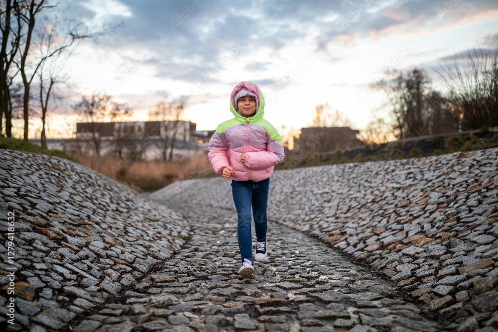 Portrait of little adorable girl walking in park