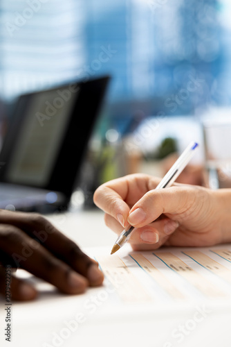 HR professional signing documents after ensuring job candidate possesses necessary qualifications fitting for company culture. Close up of recruiter signing salary package and other benefits files