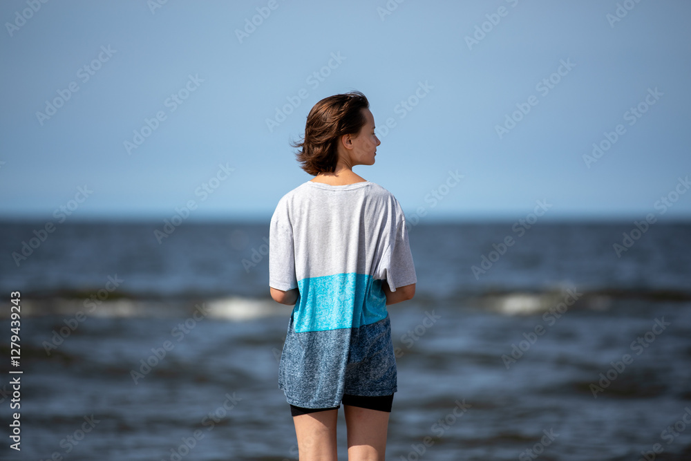 Beautiful girl walking at sea shore