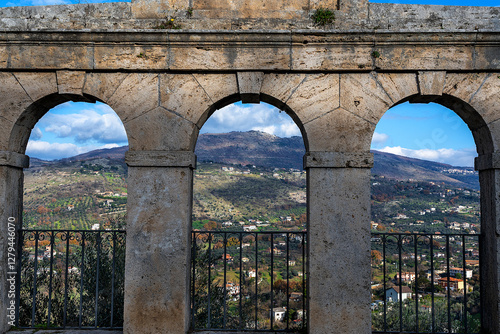Canvas Print Close-up view of the stone building with three arches framing the beautiful pano