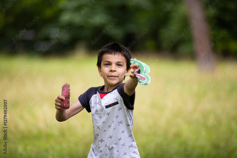 Little adorable boy paying with handmade drone in park Little adorable boy paying with handmade drone in park