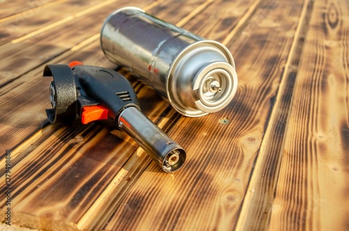 Metal gas burner on the wooden background.