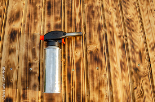 Metal gas burner on the wooden background.