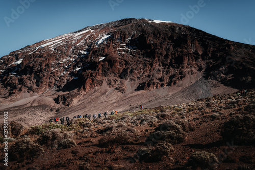 A group of hikers in a single line on the trail to Mount Kilimanjaro in Tanzania Africa