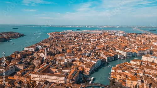 Venice from Above: Captivating aerial view of the enchanting city of Venice, Italy, showcasing its iconic waterways, historic buildings, and vibrant urban landscape under a clear, sunny sky.