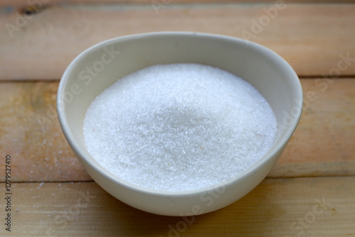 Monosodium glutamate in bowl on wooden background. photo