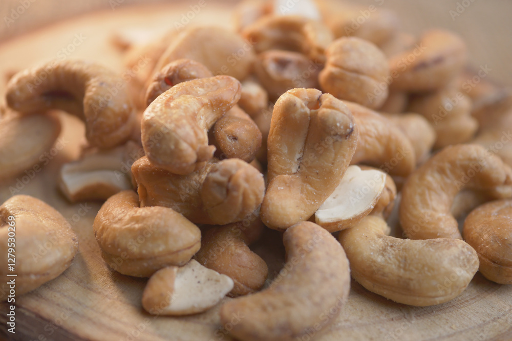 Cashews on wooden surface ready for snacking or cooking Cashews on wooden surface ready for snacking or cooking