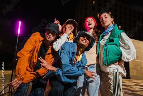 Картината върху платно Group of Young Adult Friends Posing Cheerfully in Urban Street wear Fashion with Energetic Expressions