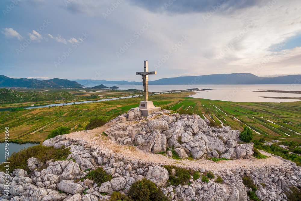 Large Hilltop Crucifix Overlooking Neretva Valley and Adriatic Sea with Scenic Landscape at Sunset in Croatia. Large Hilltop Crucifix Overlooking Neretva Valley and Adriatic Sea with Scenic Landscape at Sunset in Croatia.