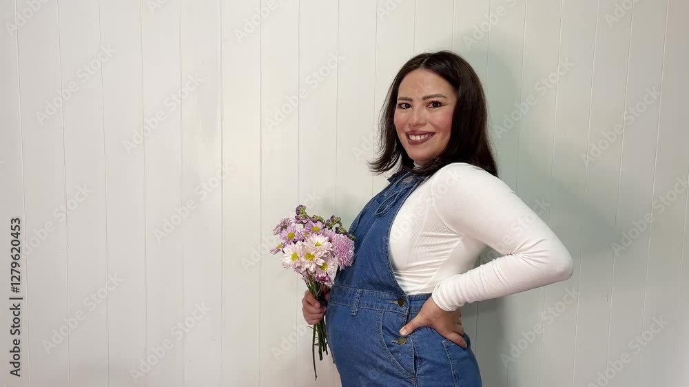 Pregnant woman smelling flowers, enjoying the scent of purple chrysanthemums Pregnant woman smelling flowers, enjoying the scent of purple chrysanthemums