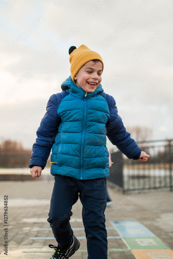 Portrait of little adorable boy walking in park