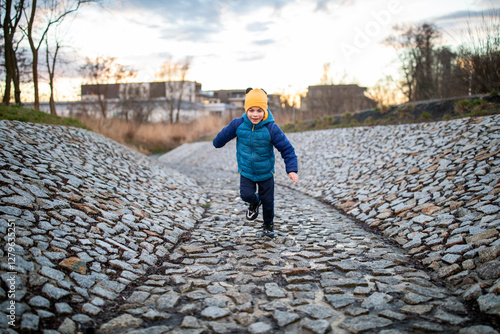 Obraz na płótnie Portrait of little adorable boy walking in park w salonie