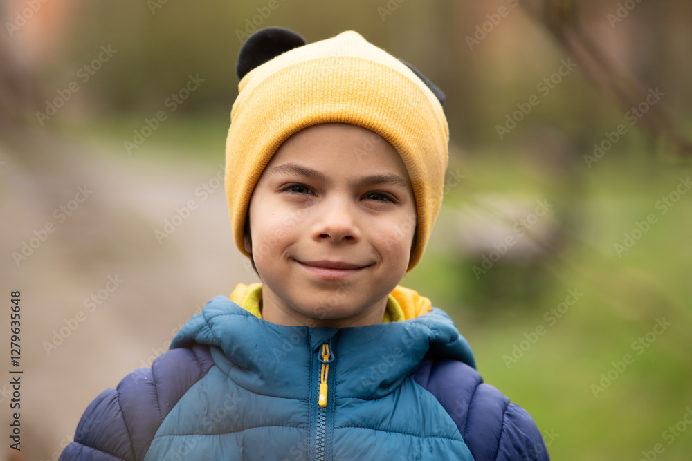 Portrait of little adorable boy walking in park
