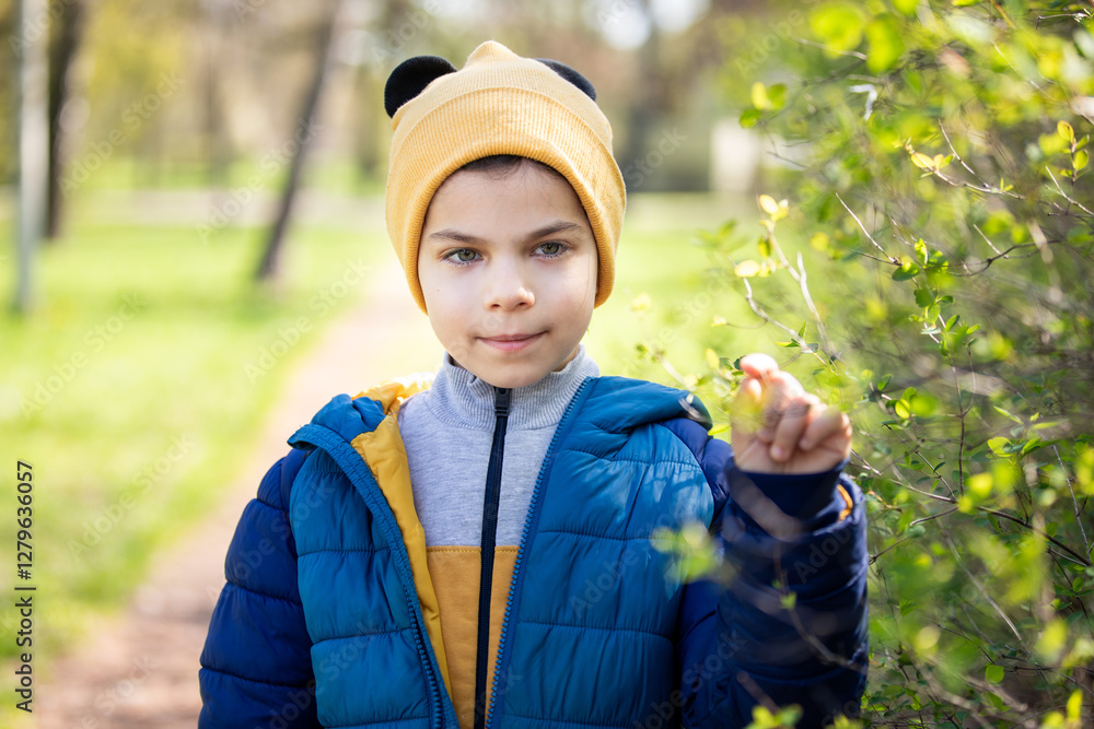 Portrait of little adorable boy walking in park