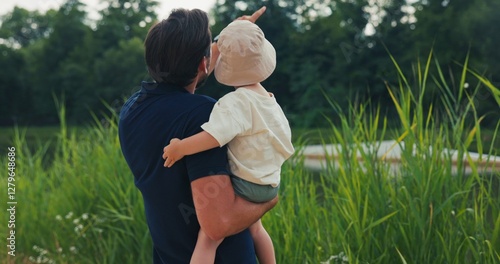 Wallpaper Mural Vacation, summer, father holds his little son in arms, boy has a hat on head, man points to something with hand, arouses child's interest, they high-five, rest by water Torontodigital.ca