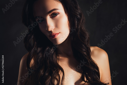 Photo of stunning girl look feel flirty tempting under bright sun light over dark color background