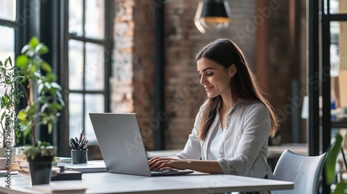 The smiling Hispanic businesswoman sitting at her desk with a confident smile...