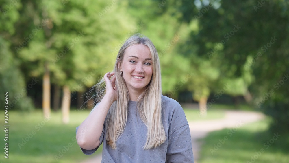 Attractive joyful woman blonde portrait in summer park Attractive joyful woman blonde portrait in summer park