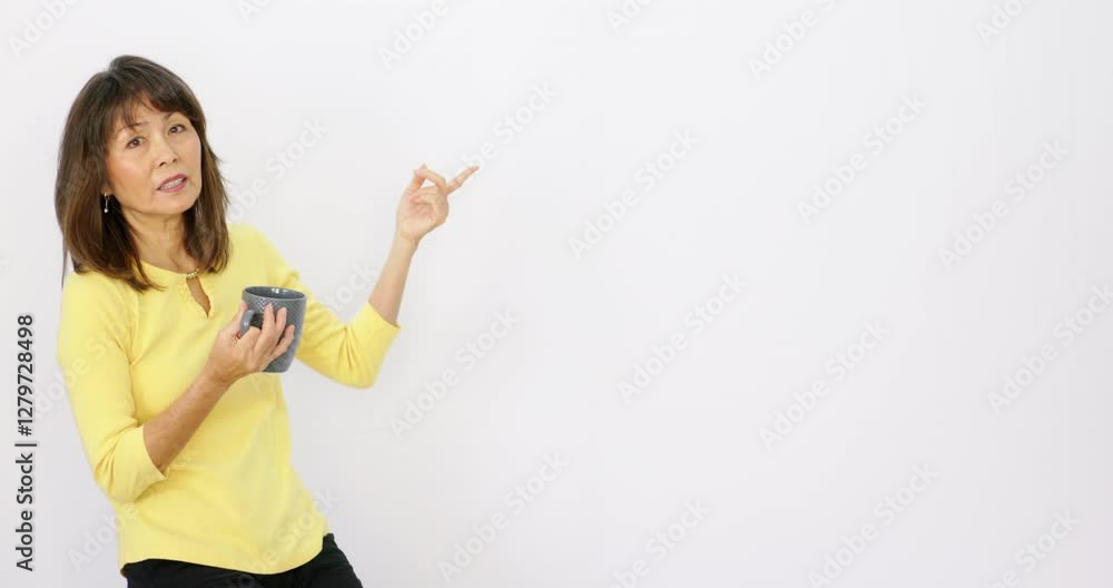 Model holding coffee pointing at text placeholder copy space white background Model holding coffee pointing at text placeholder copy space white background