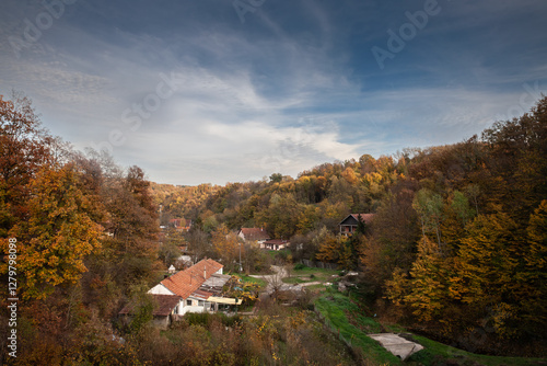 typical European countryside landscape, with a Serbian village with farms, trees, in a valley in Bela Reka, near Ripanj, Central Serbia, in autumn. photo