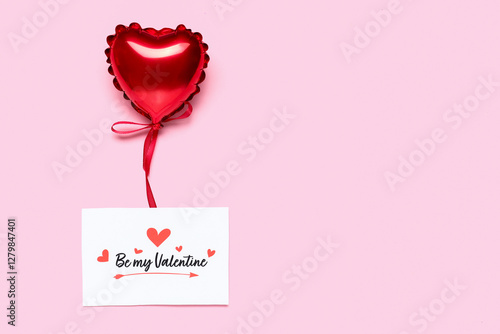 Greeting card with text BE MY VALENTINE and heart-shaped balloon on pink background