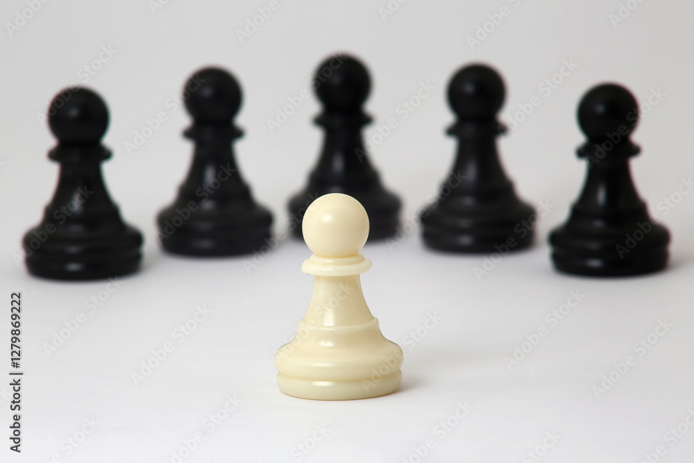 The white pawn, a symbol of resilience, faces the black army. The white pawn, a symbol of resilience, faces the black army.