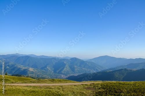 Wallpaper Mural Summer view showcasing rolling green mountains under a bright and clear blue sky. Ideal for representing nature, tranquil, and picturesque landscapes. Carpathian Mountains, Ukraine Torontodigital.ca