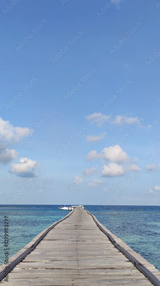 Vertical Video: Scenery of a Wooden Pier Towards a Boat in Tropical Sea, Static View Camera Angle for Background Footage Vertical Video: Scenery of a Wooden Pier Towards a Boat in Tropical Sea, Static View Camera Angle for Background Footage
