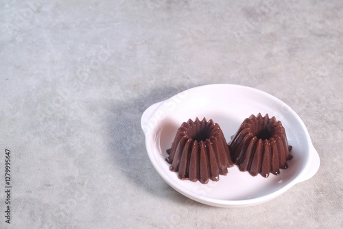 Homemade Dessert Puding coklat or chocolate pudding on white background, have a sweet taste. Made from jelly, cocoa powder, sugar, and milk.
