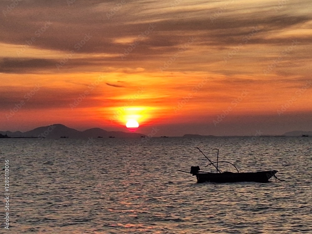 Naklejka premium fishing boat at sunset