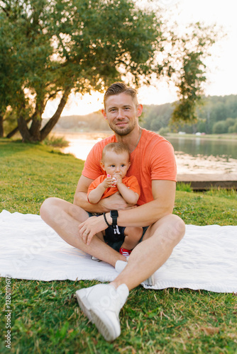 Father Holding Baby During Summer Picnic