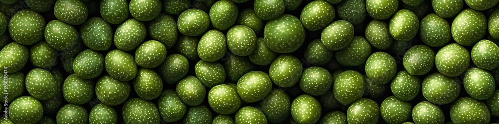 A top view of green olives, neatly arranged in rows on a background. A top view of green olives, neatly arranged in rows on a background.