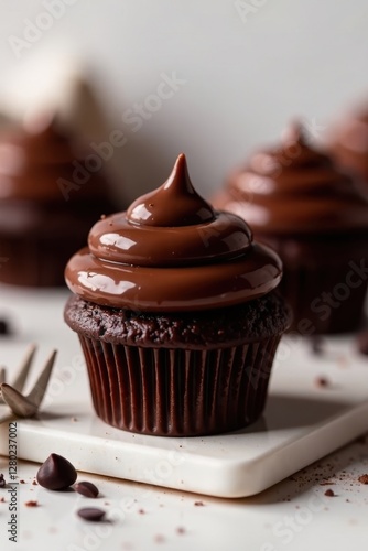 Decadent dark chocolate cupcakes topped with smooth ganache, intense flavor, cocoa, dessert