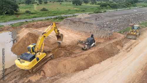 Yellow Excavator Performing Earthworks at Construction Site