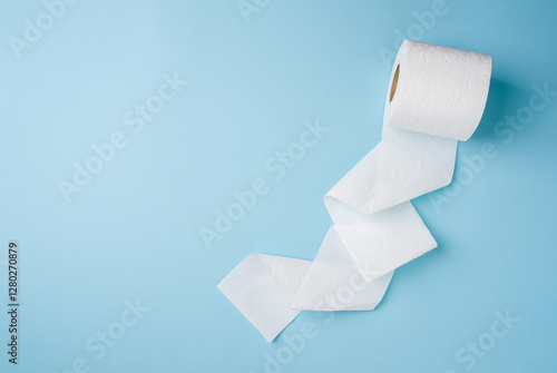 Top view of toilet paper roll on blue background