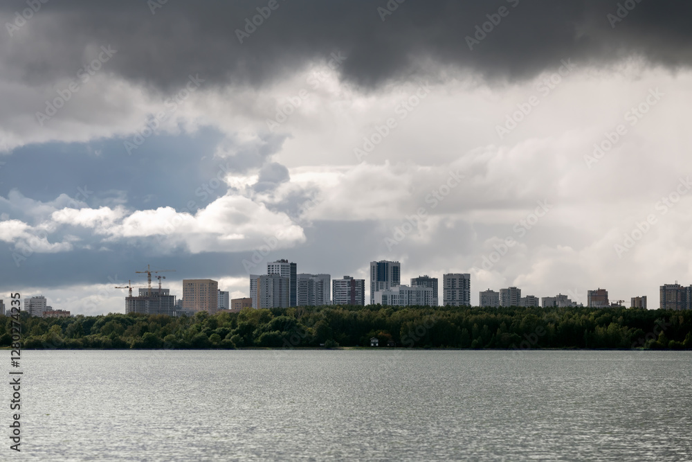 Residential buildings of the city on the horizon above the water of the lake Shartash in the Shartash Forest Park. Ekaterinburg Residential buildings of the city on the horizon above the water of the lake Shartash in the Shartash Forest Park. Ekaterinburg