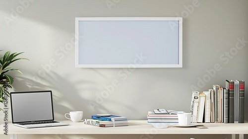 A white rectangular frame above a desk in a modern home office  surrounded by a coffee cup  a laptop  and a stack of books  HD 8K mockup wallpaper Photographic Image