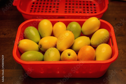 Wallpaper Mural Mangoes in basket on dark brown wooden surface Torontodigital.ca