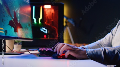 Fotografia Man using gaming RGB lit mouse to shoot asteroids in spaceship flying videogame