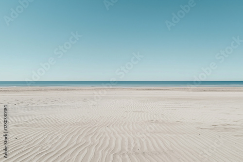 Fototapeta Naklejka Na Ścianę i Meble -  wide camera angle captures deserted sand beach under clear blue sky