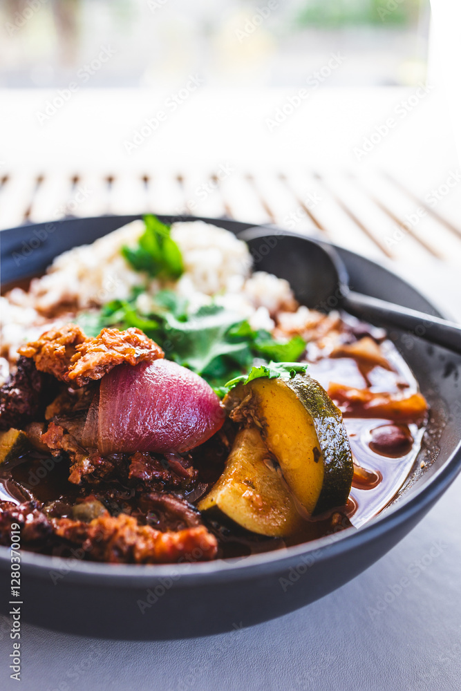 plant-based curry with onion and zucchini in spicy sauce with rice plant-based curry with onion and zucchini in spicy sauce with rice