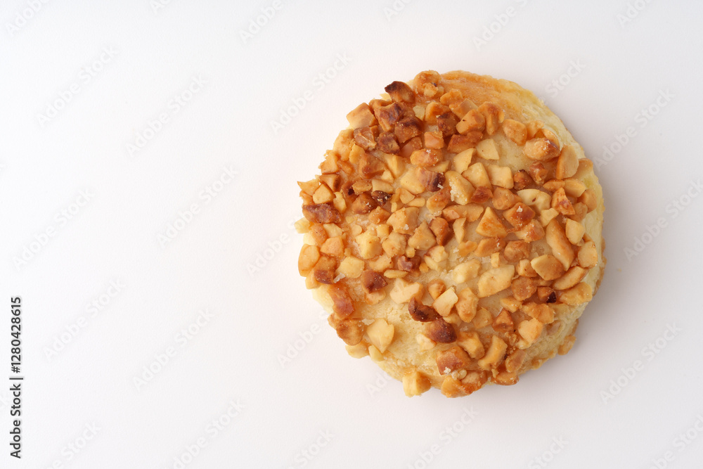 Crunchy nut-topped dessert resting on a light background showcasing delicious pastry appeal Crunchy nut-topped dessert resting on a light background showcasing delicious pastry appeal