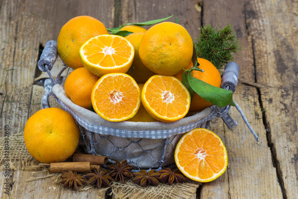 fresh tangerines in a basket on old wooden background