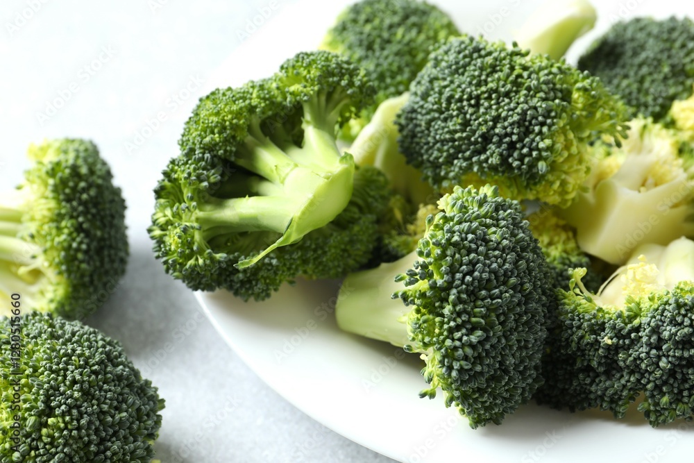 Fresh green broccoli in a plate on gray table Fresh green broccoli in a plate on gray table