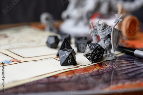 Close up of black d20 on character sheet. Board games, RPG, abstract concept of randomness and chance. Dice game, RPG