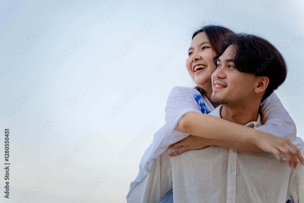 Couple in love. a young funny couple piggybacking on the beach